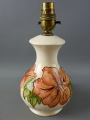 A MOORCROFT CORAL HIBISCUS POTTERY TABLE LAMP, decorated on an ivory ground, impressed to the
