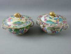 A PAIR OF CHINESE PORCELAIN TWIN HANDLED SOUP BOWLS WITH COVERS, decorated in Canton enamels showing