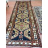 A GOOD SIZE RED GROUND EASTERN WOOLLEN CARPET with large floral decorated central medallion and wide