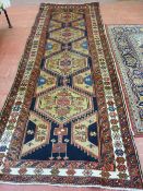 A GOOD SIZE RED GROUND EASTERN WOOLLEN CARPET with large floral decorated central medallion and wide