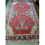 AN OLD PERSIAN HAMADAN LORI VILLAGE RUG, red ground with twin urn motifs, floral sprays and cut