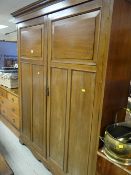 A vintage mahogany double wardrobe with internal drawers