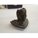 A cast metal bust of a Native American Indian (probably a finial from a gaming machine)