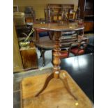 An antique circular topped tripod occasional table