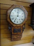 An antique marquetry wall clock