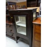 A vintage single-door cabinet with two internal shelves