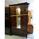 A vintage mahogany single-door wardrobe with carved detail on base drawer