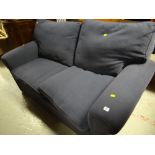 A modern two-seater blue fabric sofa bed