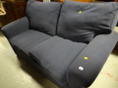 A modern two-seater blue fabric sofa bed