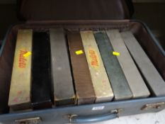 A vintage suitcase of boxed pianola rolls
