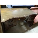 A good early twentieth century carved serpentine front desk on ball & claw supports with a bank of