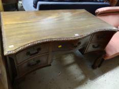 A good early twentieth century carved serpentine front desk on ball & claw supports with a bank of
