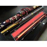 A hard cased two-piece snooker cue together with a leather cased pair of snooker cues & a