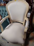 A white painted French-style elbow chair
