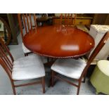 A good modern extending circle / oval dining table & four chairs