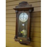 An oak encased circular dial wall clock