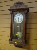 An oak encased circular dial wall clock