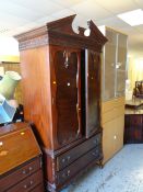 An antique-style mahogany armoire with two base drawers & carved details