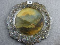A CIRCULAR PAPIER MACHE PLATE BY JENNENS & BETTRIDGE and having a wavy wide border with mother-of-