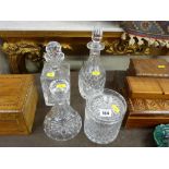 Three good decanters and a lidded glass biscuit jar