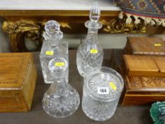 Three good decanters and a lidded glass biscuit jar