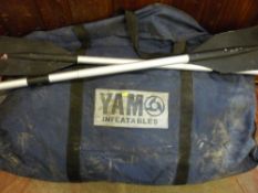 Cased Yam inflatable boat with a pair of oars