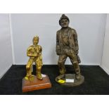 Brass miner figurine on a wooden stand and another resin made