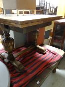 An antique oak extending dining table together with a vintage light oak drawer leaf dining table