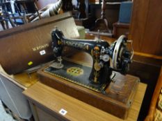 A vintage cased Singer table top sewing machine