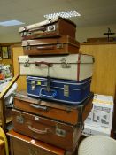 A parcel of various vintage suitcases