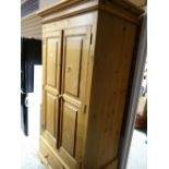 A good two-door pine wardrobe with single-drawer base