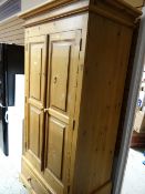 A good two-door pine wardrobe with single-drawer base
