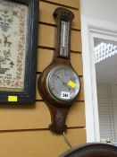A small oak encased aneroid barometer