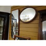 A small mahogany framed oval wall mirror together with a modern hall mirror