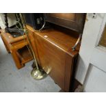 A vintage light oak drop leaf dining table