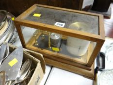 A vintage barograph in a glass case