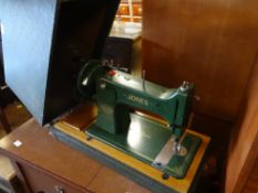 A vintage cased Jones of Manchester sewing machine together with a sewing machine table