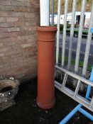 A tall earthenware chimney pot (outside)