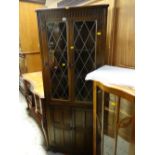 A vintage Old Charm-style dark oak standing corner cupboard with two-door cupboard base & leaded