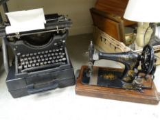 A vintage cased Singer sewing machine together with an Underwood typewriter etc