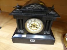 An antique architectural slate mantel clock