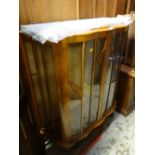 A vintage mahogany bow fronted glass display cabinet