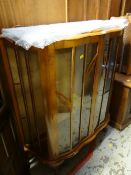 A vintage mahogany bow fronted glass display cabinet