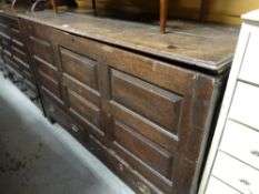 An antique oak coffer with two drawers to the base