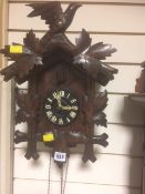 A Black Forest-style carved cuckoo clock