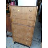 A vintage G-plan tall seven-drawer chest of drawers together with a mirror & frame