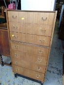 A vintage G-plan tall seven-drawer chest of drawers together with a mirror & frame