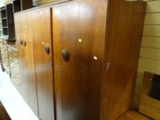 A 1970s polished wood bedroom suite comprising dressing table together with gentleman & ladies'