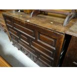 An antique oak coffer with shaped front & three drawers to the base