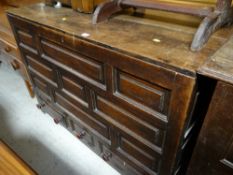 An antique oak coffer with shaped front & three drawers to the base